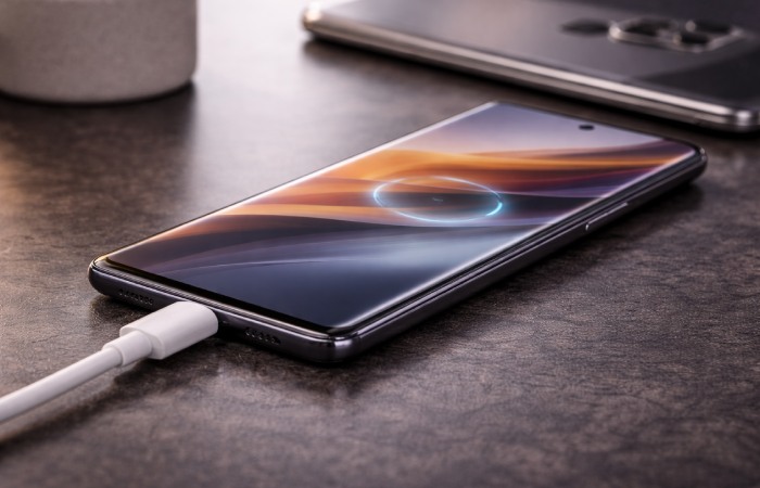 Motorola Edge 50 Pro connected to charger on desk